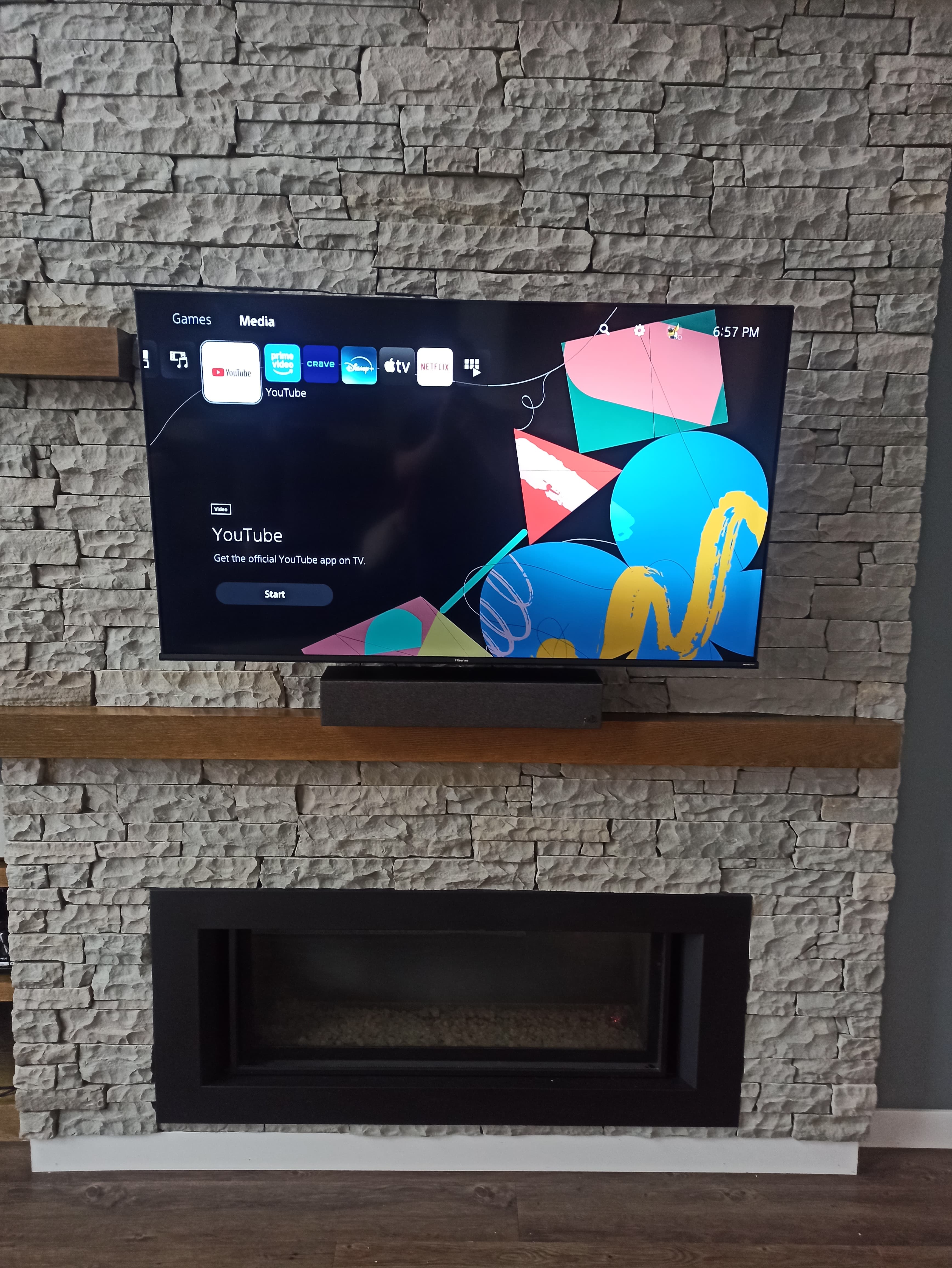 TV installation on stone fireplace wall Winnipeg